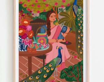 May include: A framed art print depicts a woman in a pink sari reading a book on a patio. Two peacocks and a tea set are also present. The background features lush greenery and flowers, with a light wood frame.
