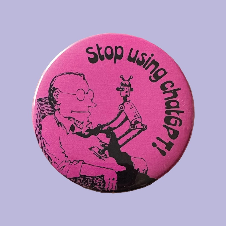 May include: A round, pink button with the text "stop using chatGPT!" in black. The button features a cartoon illustration of a man in a chair interacting with a robot. The design is a humorous commentary on technology.