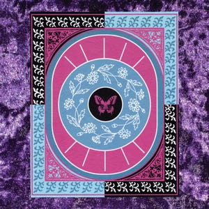 May include: A rectangular print featuring a central black circle containing a pink butterfly, surrounded by a white floral wreath. The design includes concentric pink and blue circles, framed by a border with black and blue floral patterns.