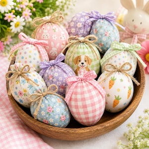 May include: A collection of decorative fabric eggs in a wooden bowl, featuring various patterns including gingham, polka dots, floral prints, and bunny motifs. Each egg is topped with a small tied ribbon or twine bow in coordinating colors.