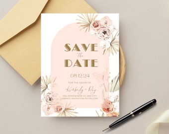May include: A wedding "Save the Date" card with a blush pink arch design and floral accents. The card features the text "SAVE THE DATE" in gold lettering, along with the date "08.12.24" and the names "Kimberly & Ray". An envelope and pen are also visible.