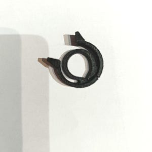 May include: A black plastic ring with a textured surface.