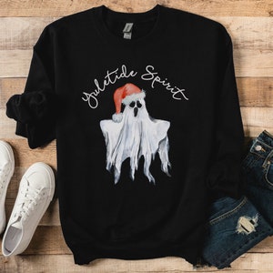May include: Black sweatshirt with a white ghost wearing a Santa hat and the text "yuletide spirit" in white.