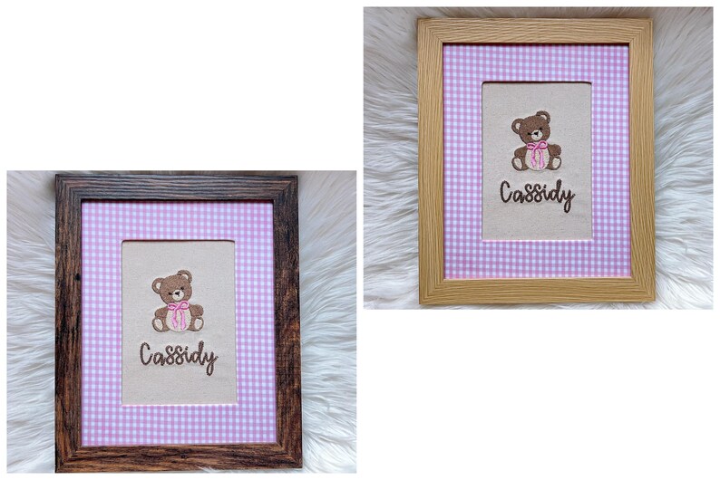 May include: Two framed embroidered pictures. Each features a brown teddy bear with a pink bow and the name "Cassidy" in script. The background is a light-colored fabric with a pink and white gingham pattern.