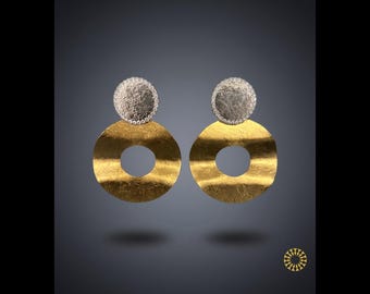 Elevate your collection with these masterfully crafted drop earrings. A radiant silver-tone circular disc with a hammered "moon-crater".