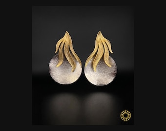 Elevate your look with these striking mixed-metal earrings, where organic movement meets modern sophistication.