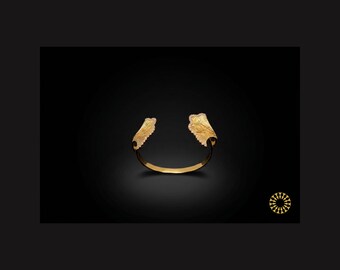 This elegant crafted cuff bracelet features an intricate ginkgo leaf motif that elegance to your look.