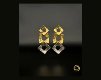 A modern futuristic look with handmade two warm gold-toned square elements at the top to a contrasting cool silver-toned square at the base