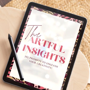Puede incluir: Una tableta digital con un marco negro y un borde de estampado animal rosa y negro. La pantalla muestra el texto "The Artful Insights 365 Prompts to Unleash Your Creativity!"