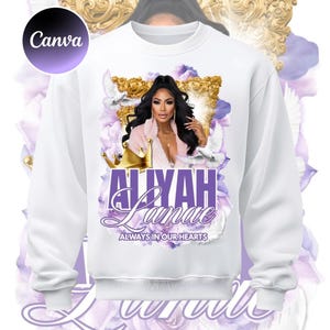May include: White sweatshirt with a memorial design. The design includes a portrait of a woman, the name "ALIYAH Lanae", and the phrase "ALWAYS IN OUR HEARTS". The design is surrounded by floral and dove imagery, with the word "Canva" in the upper left corner.