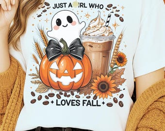May include: White t-shirt with a fall-themed graphic. The design includes a smiling ghost, an orange jack-o'-lantern with a black bow, a coffee drink, sunflowers, and the text "JUST A GIRL WHO LOVES FALL."