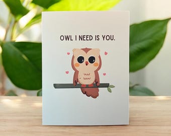 May include: A white card with a brown owl with big eyes and pink hearts. The card says "Owl I need is you."