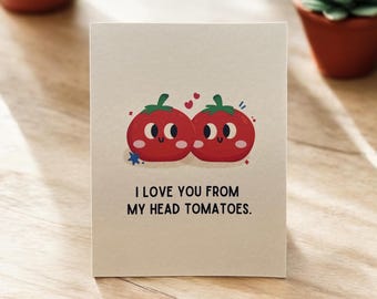 May include: A card with a red and white illustration of two tomatoes with faces. The text on the card reads "I love you from my head tomatoes."