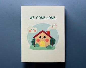 May include: A greeting card with a cartoon illustration of a house, clouds, and the text "WELCOME HOME." The house has a red roof, a yellow door, and green bushes. The background is a light blue circle.