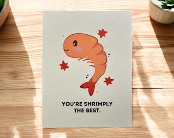 May include: A greeting card with a cartoon shrimp illustration and the text "You're shrimply the best."