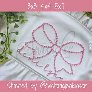 May include: A pink embroidered bow with a name "Demi Lynn" stitched underneath. The text "Stitched by @victoriajenkinson" is at the bottom of the image.