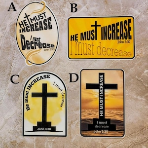 May include: Four different stickers with a yellow background and black text. Each sticker features a cross and the text "He must increase, I must decrease" with the Bible verse John 3:30. The stickers have different designs, including a watercolor background, a sunset background, and a simple design with a cross.