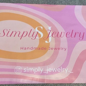 Pode incluir: Faixa de padr&atilde;o de redemoinho rosa e laranja com o texto "Simply SJ Jewelry" e "Handmade Jewelry". A faixa tamb&eacute;m inclui o &iacute;cone do Instagram e o texto "simply_jewelry_"
