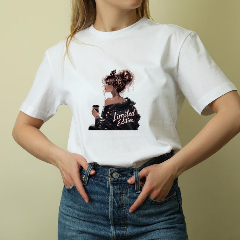 May include: White t-shirt featuring a graphic of a woman with a coffee cup, wearing a black jacket with the text "Limited Edition". The woman has a leopard print headband and her hair is styled in a bun. The t-shirt is paired with blue jeans.
