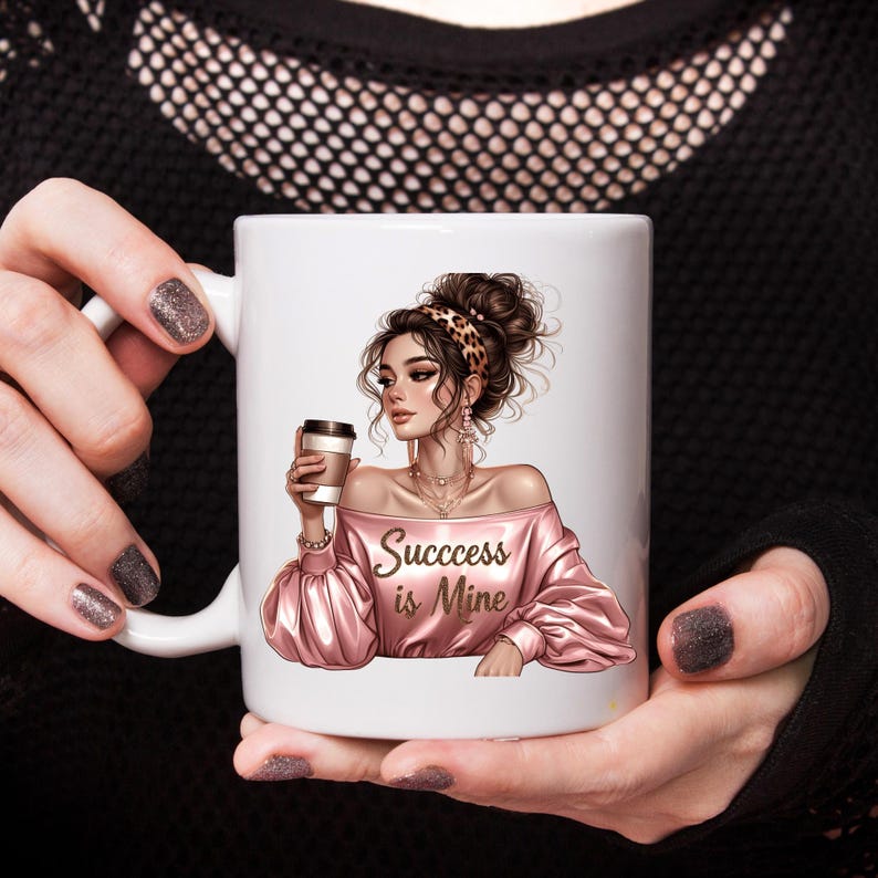 May include: White ceramic coffee mug featuring an illustration of a woman in a pink off-the-shoulder top holding a coffee cup. The text "Success is Mine" is printed on the front. The woman has a leopard print headband.