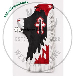May include: A pair of kid's chaps featuring a black, white, and red color scheme. The design includes a white cross emblem with red trim, long white fringe along the side, and a buckle closure at the top. The text Mira Western Store is visible.