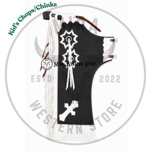 May include: Kid's chaps featuring a black leather base with white leather fringe along the side. The design includes white star-shaped and cross-shaped appliqués, brown leather straps with silver-toned buckles, and the text Kid's Chaps/Chinks.