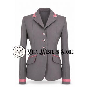 May include: A grey equestrian-style blazer featuring a notched lapel with pink trim, four decorative crystal buttons down the front, and two flap pockets with pink piping. The cuffs are finished with pink bands. Text reads Mira Western Store.