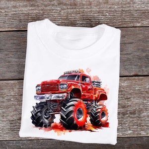 May include: A white t-shirt with a red monster truck graphic. The truck has large tires and is surrounded by a watercolor effect.