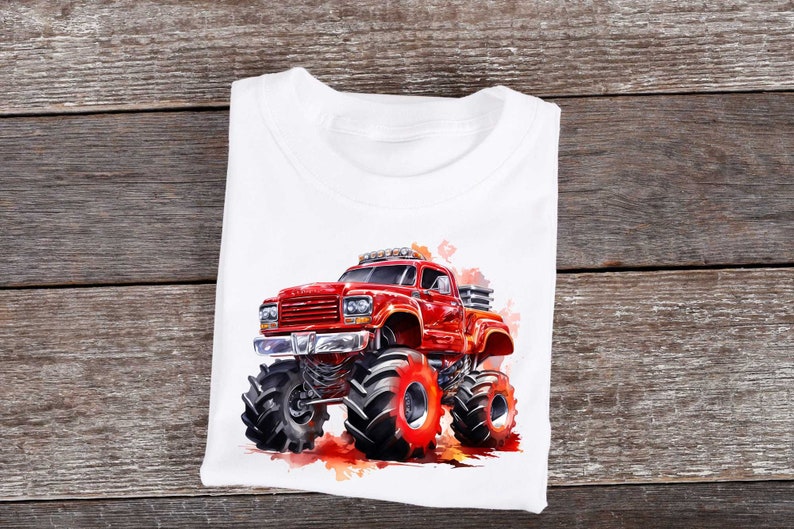 May include: A white t-shirt with a red monster truck graphic. The truck has large tires and is surrounded by a watercolor effect.