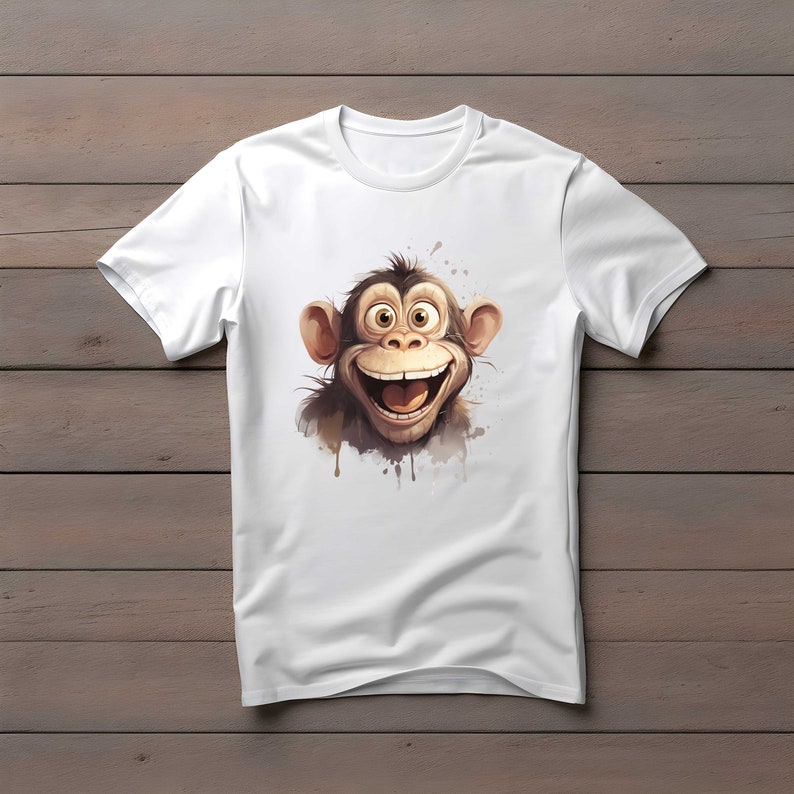 Puede incluir: Camiseta blanca con una imagen de dibujos animados de un mono sonriente con pelaje marr&oacute;n y ojos grandes.