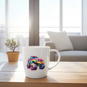 May include: A white ceramic coffee mug with a colorful watercolor illustration of a monster truck. The truck is painted in shades of red, orange, yellow, green, blue, and purple.