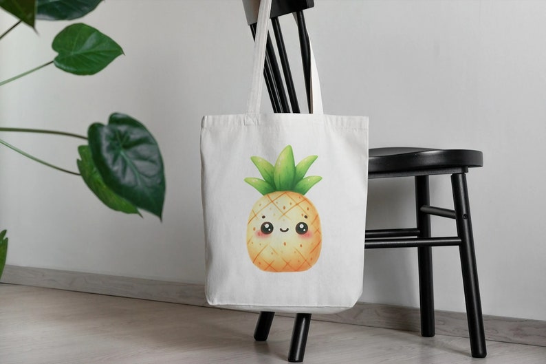 K&ouml;nnte beinhalten: Wei&szlig;e Einkaufstasche mit einem Cartoon-Ananas-Design. Die Ananas hat ein l&auml;chelndes Gesicht und ist gelb mit gr&uuml;nen Bl&auml;ttern.