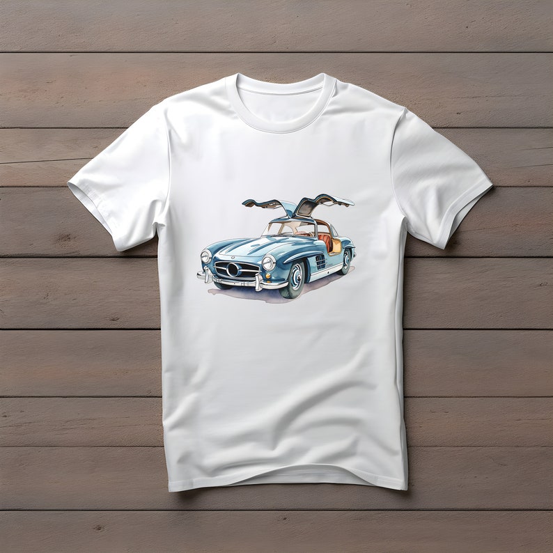 May include: A white t-shirt with a blue and silver vintage car illustration. The car has its doors open and the roof is up.