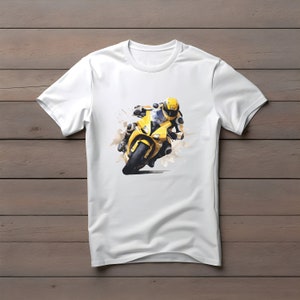 May include: White t-shirt with a graphic of a yellow motorcycle and rider in a yellow helmet, speeding through a cloud of dust.
