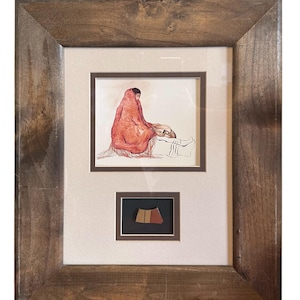 May include: A framed watercolor painting of a woman in a red shawl sitting with a child. A small piece of pottery is displayed below the painting.