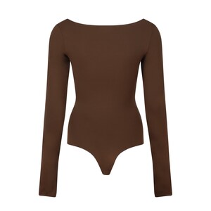 May include: A brown long-sleeved bodysuit with a scoop neck.