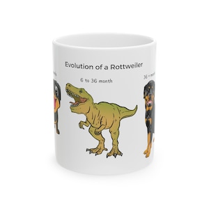 May include: White ceramic mug with a cartoon illustration of the evolution of a Rottweiler. The mug features a Rottweiler puppy, a dinosaur, and a full-grown Rottweiler. The text on the mug reads "Evolution of a Rottweiler" and "6 to 36 month".