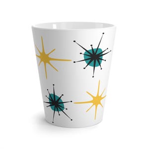 May include: White ceramic mug with a retro mid-century modern design featuring black and teal stars with yellow accents.