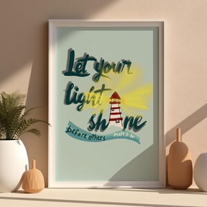 May include: A framed print with a blue background and a lighthouse illustration. The text reads "Let your light shine before others Matt 5:16".