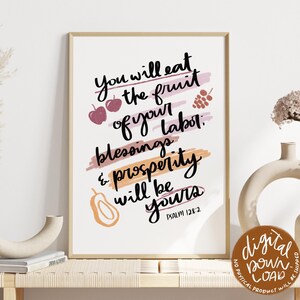 May include: A framed art print with the text "You will eat the fruit of your labor: blessings & prosperity will be yours. Psalm 128:2." The print features illustrations of apples, grapes, and a pear, with a digital download label.