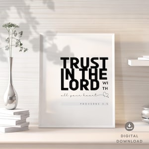 Puede incluir: Una impresión enmarcada blanca con texto negro que dice "TRUST IN THE LORD with all your heart" y "PROVERBS 3:5".