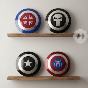 May include: Four circular shields displayed on two wooden shelves. The top left shield features a Union Jack design, the top right a white skull emblem on black, the bottom left a white star on black, and the bottom right a blue spider icon.