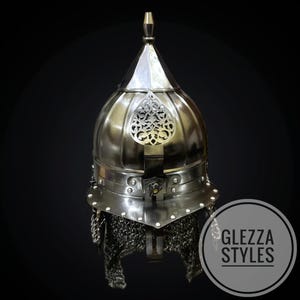 May include: A silver helmet with a pointed top and ornate metal detailing. The helmet has a chainmail neck guard and a decorative emblem on the front. The image includes the text "GLEZZA STYLES" within a circular logo.