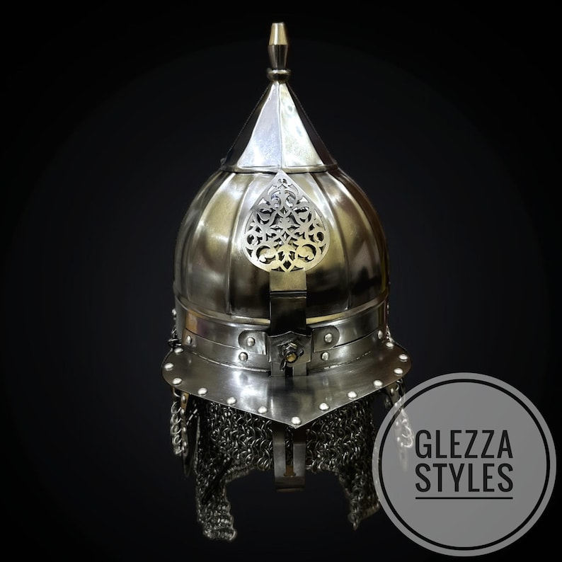 May include: A silver helmet with a pointed top and ornate metal detailing. The helmet has a chainmail neck guard and a decorative emblem on the front. The image includes the text "GLEZZA STYLES" within a circular logo.