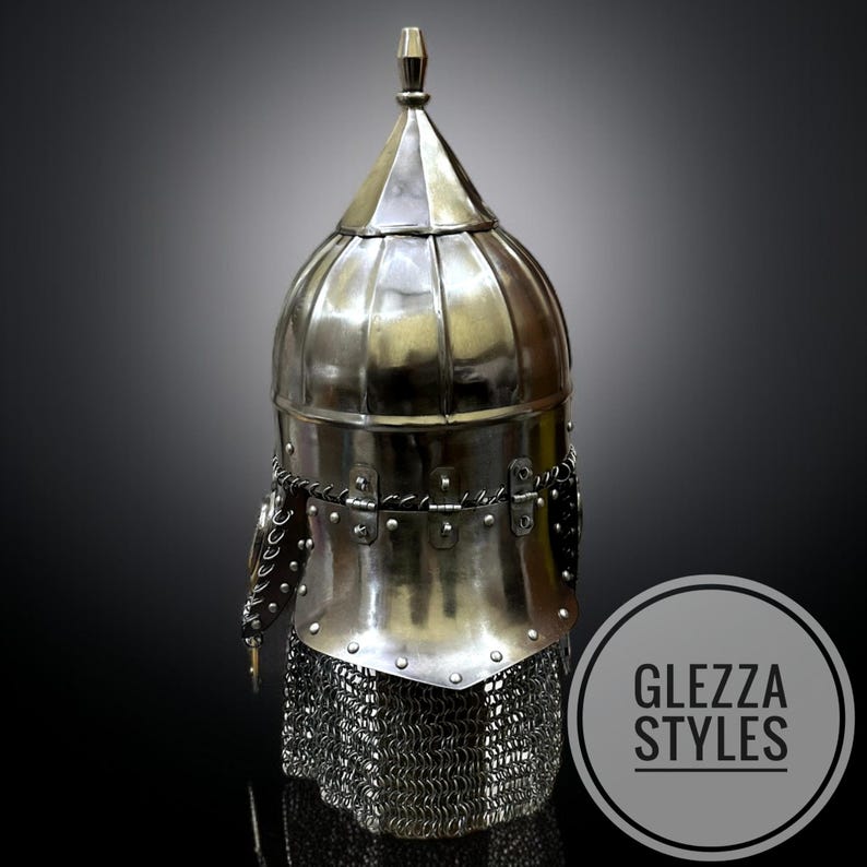 May include: A silver medieval helmet with a chainmail neck guard. The helmet features a rounded top with a pointed finial and is decorated with rivets and metal detailing. The image includes the text "GLEZZA STYLES" within a circular logo.