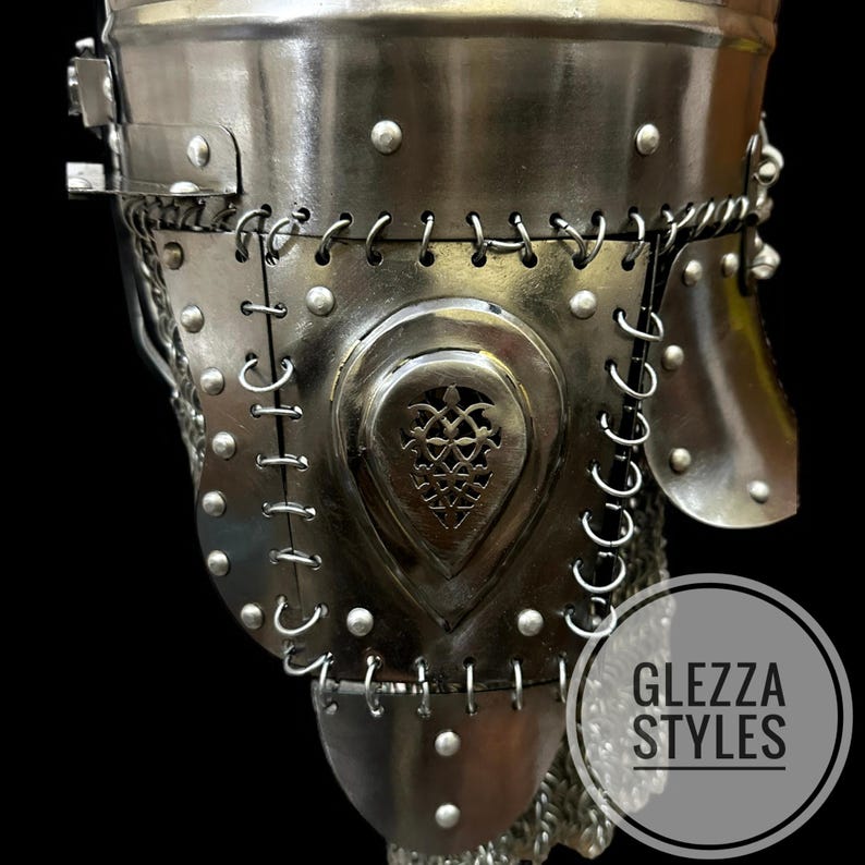 May include: A detailed view of a medieval metal helmet, showing riveted plates and decorative stitching. The helmet has a heart-shaped central design with an intricate pattern. The text "GLEZZA STYLES" is in a circle at the bottom right.