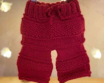 Red hand knitted trousers to fit newborn - 3 months