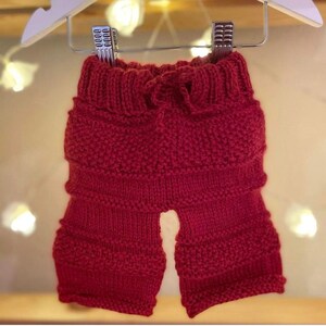 Red hand knitted trousers to fit newborn - 3 months