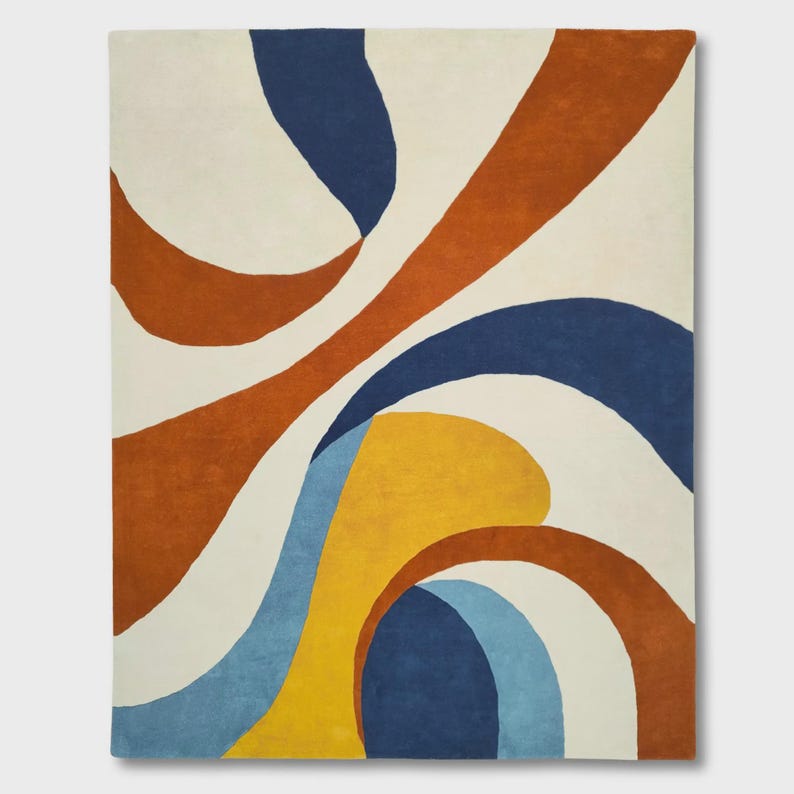 May include: A rectangular area rug featuring a large-scale abstract pattern of sweeping, curved shapes. The design consists of bold, solid color blocks in deep navy blue, burnt orange, mustard yellow, and light blue against a cream-colored background.