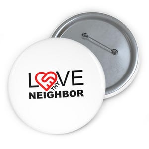 May include: White button with a red heart and the text "LOVE THY NEIGHBOR" in black.